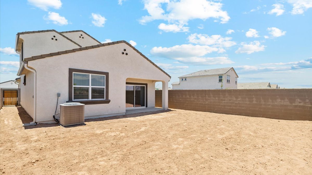Large fenced-in backyard with a covered patio, perfect for outdoor entertaining.