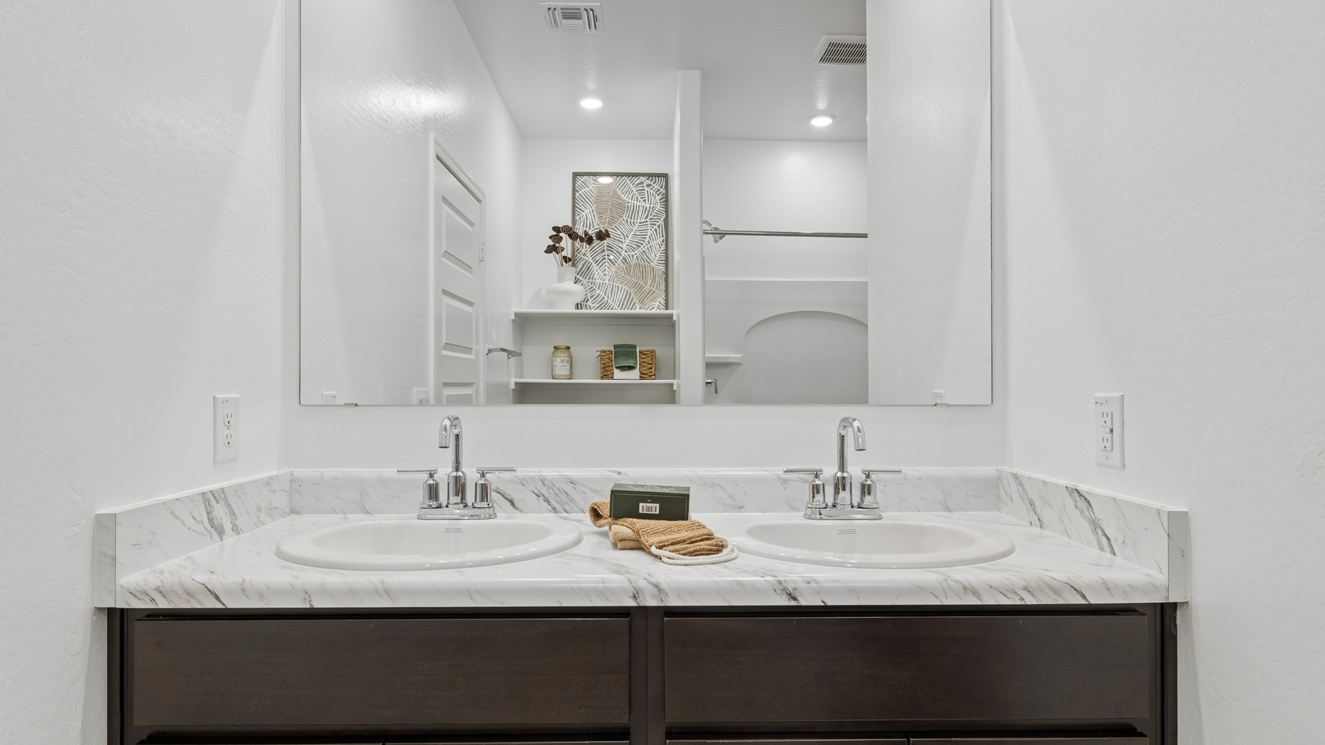 primary bathroom with dual vanities