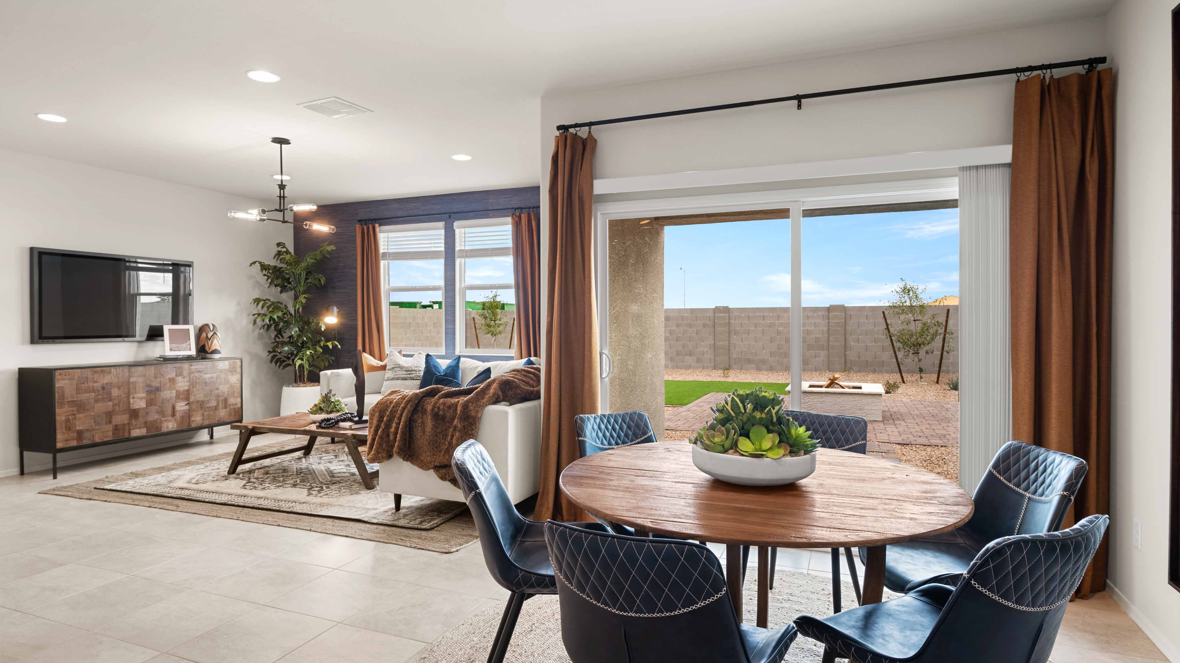 A well-organized living room that includes a kitchen and dining area, creating a warm and welcoming environment for gatherings.
