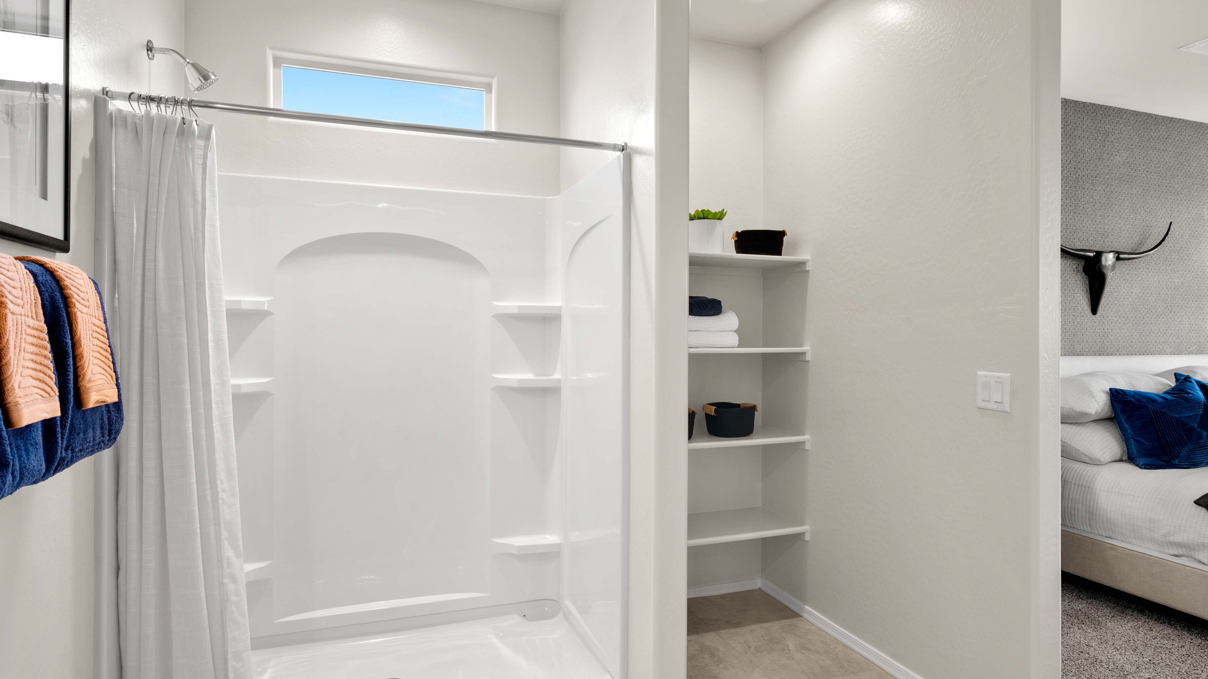 Modern primary bathroom with double vanity, granite countertops with a walk-in shower and a walk-in closet.