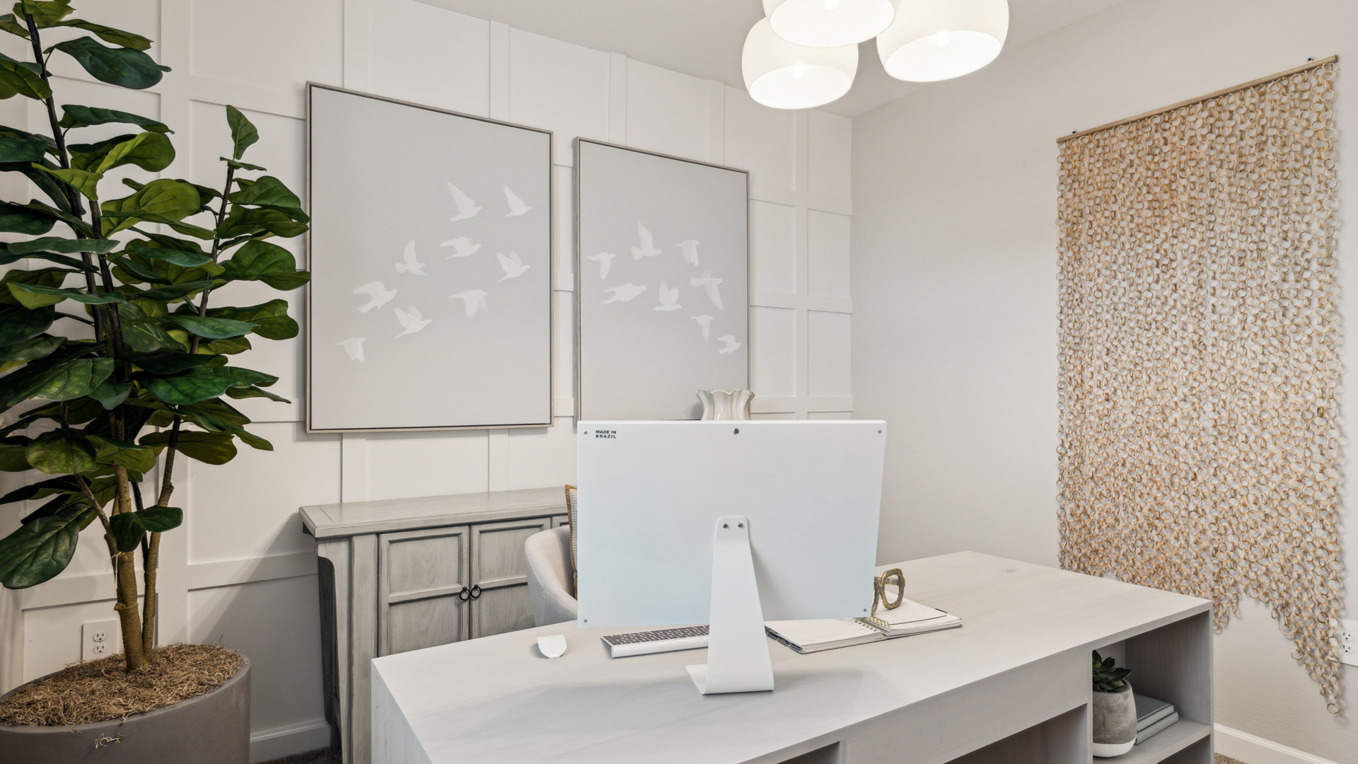 A tidy office featuring a desk, chair, and a window, creating a bright and organized workspace.