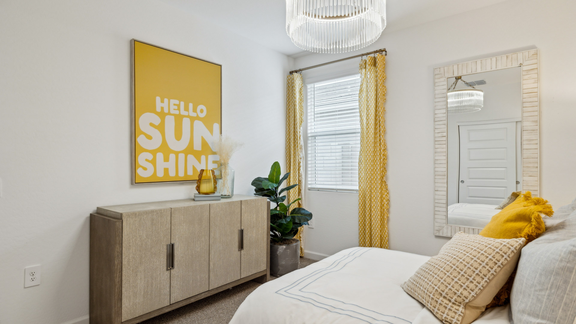 A vibrant kids' bedroom showcasing a neatly made bed, a stylish dresser, and a playful painting that adds charm.