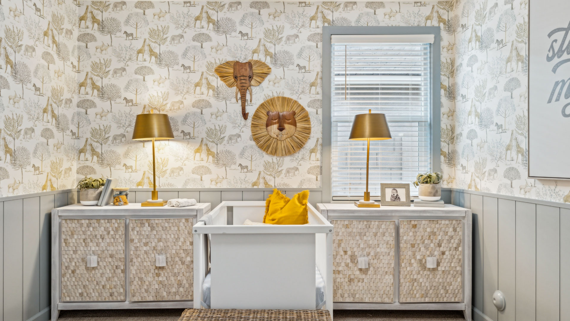 A cozy baby's room featuring a crib, a comfortable chair, and a bright window allowing natural light to enter.