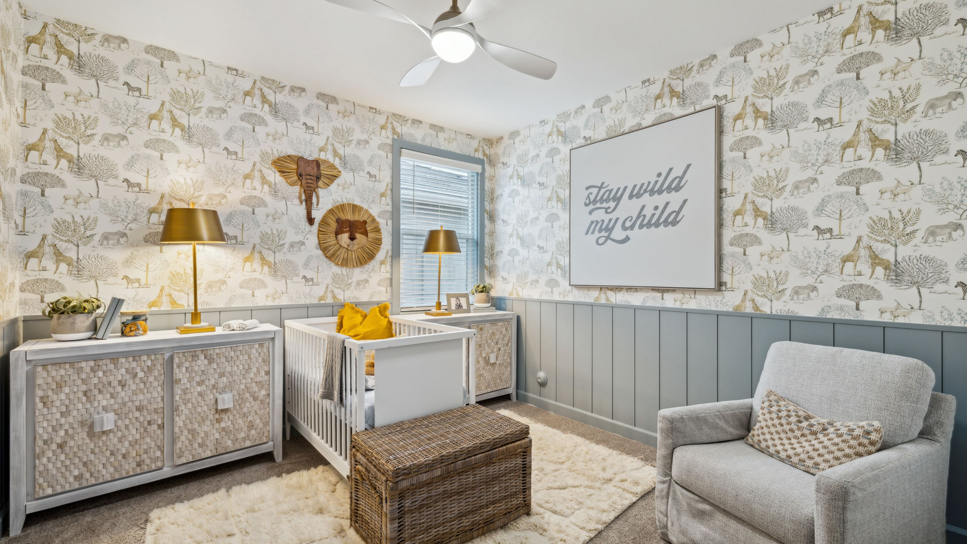 A cozy baby's room featuring a crib, a comfortable chair, and a bright window allowing natural light to enter.