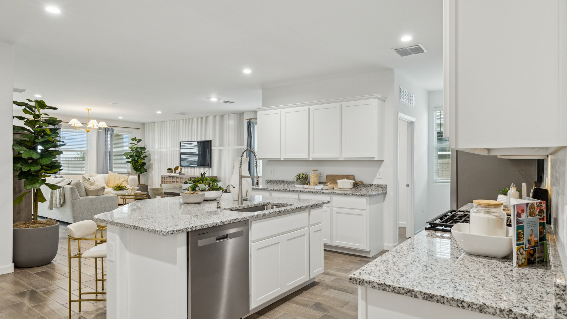 Bright and spacious kitchen with granite countertops, stainless steel appliances, and an island with bar seating.