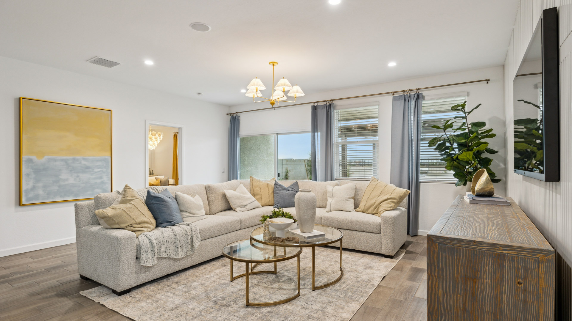 A well-organized living room that includes a kitchen and dining area, creating a warm and welcoming environment for gatherings.