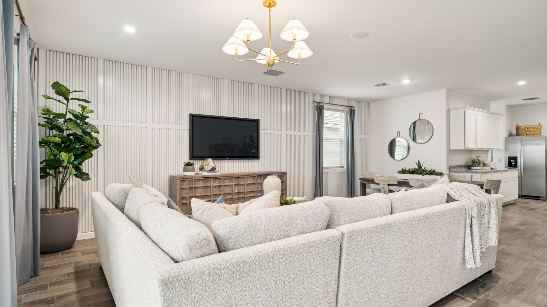 A well-organized living room that includes a kitchen and dining area, creating a warm and welcoming environment for gatherings.