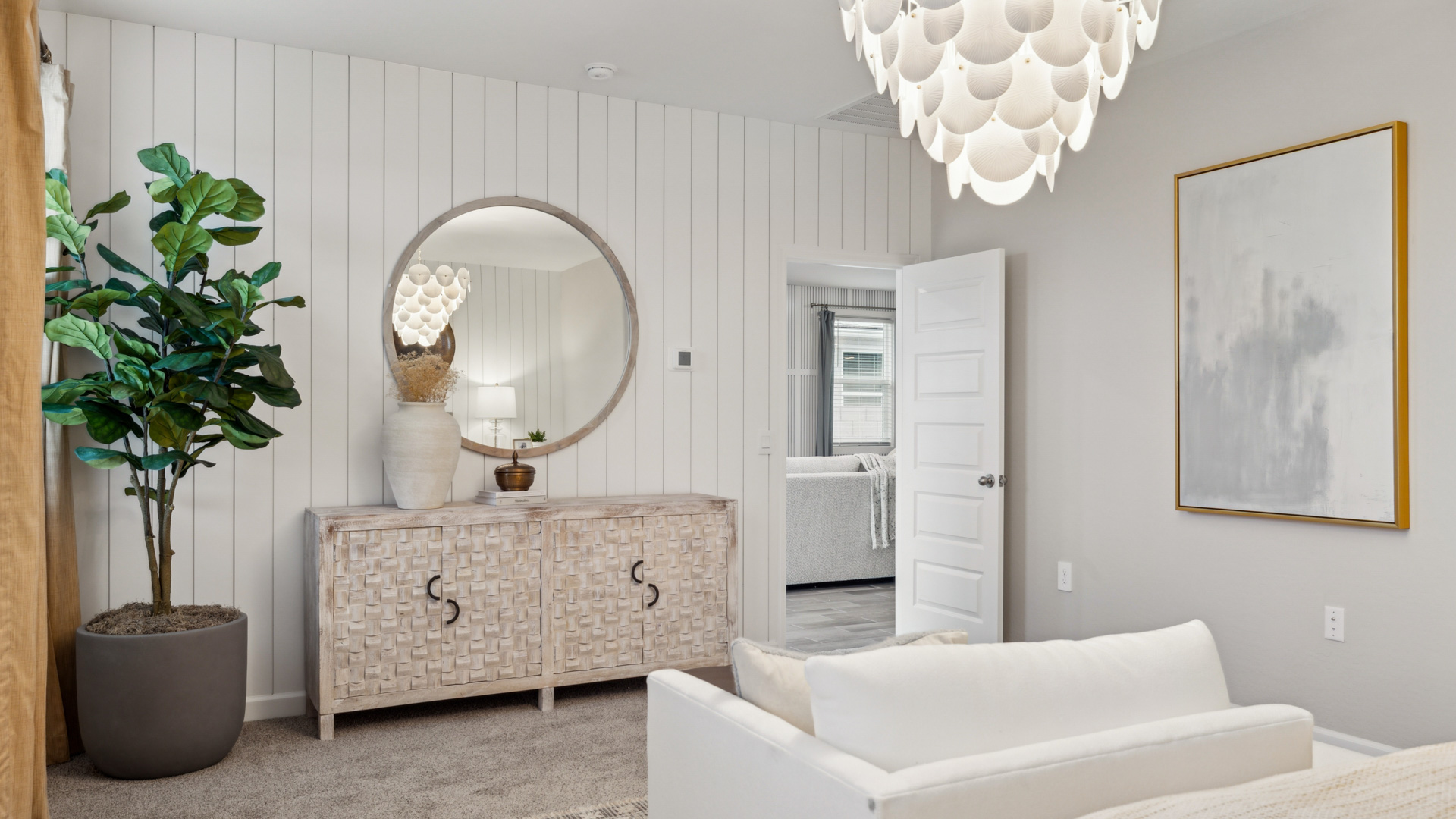 A spacious primary bedroom emphasizing open space and natural lighting.