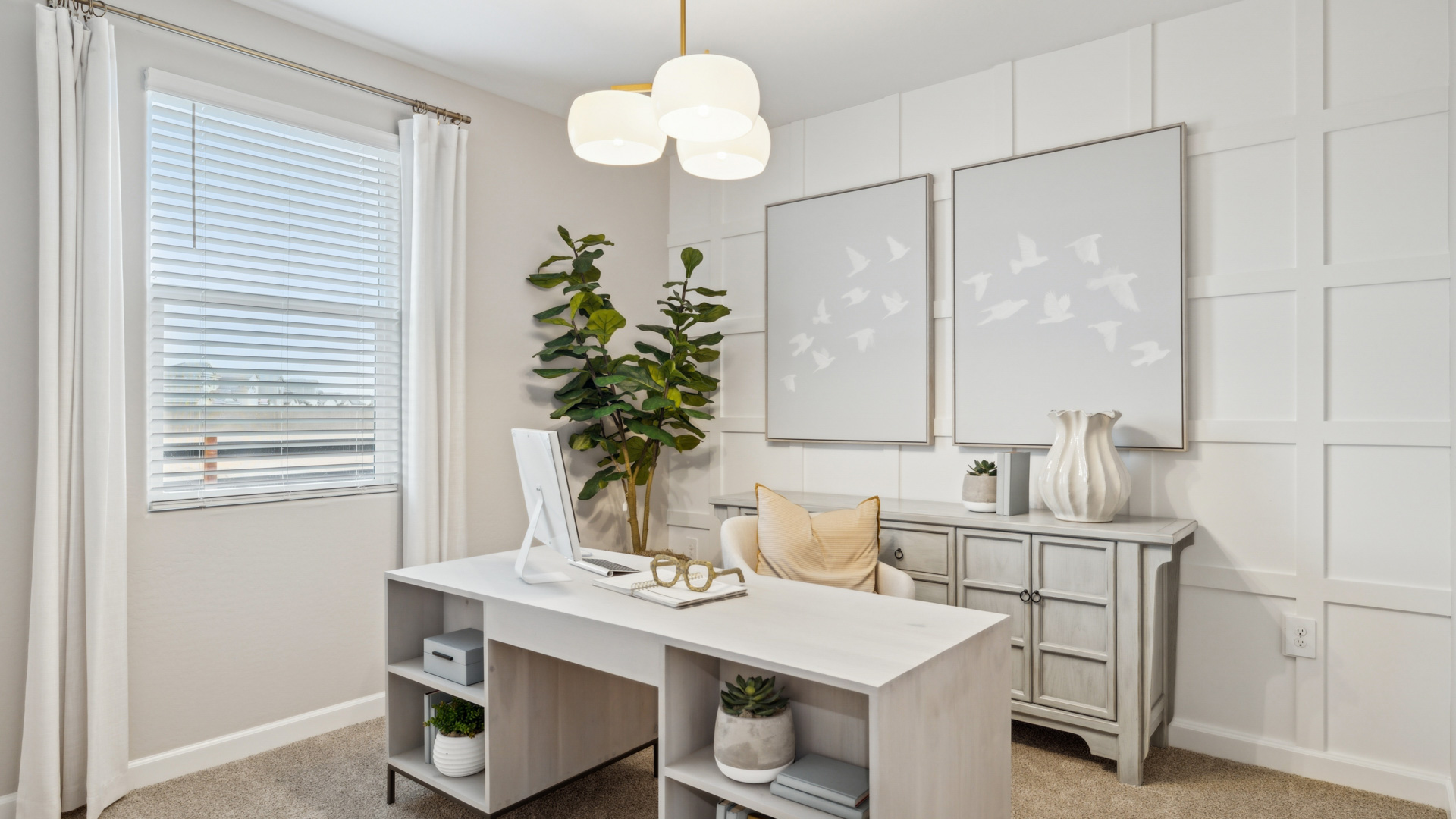 A tidy office featuring a desk, chair, and a window, creating a bright and organized workspace.