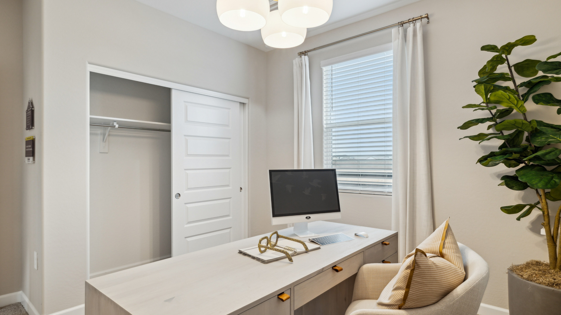 A tidy office featuring a desk, chair, and a window, creating a bright and organized workspace.