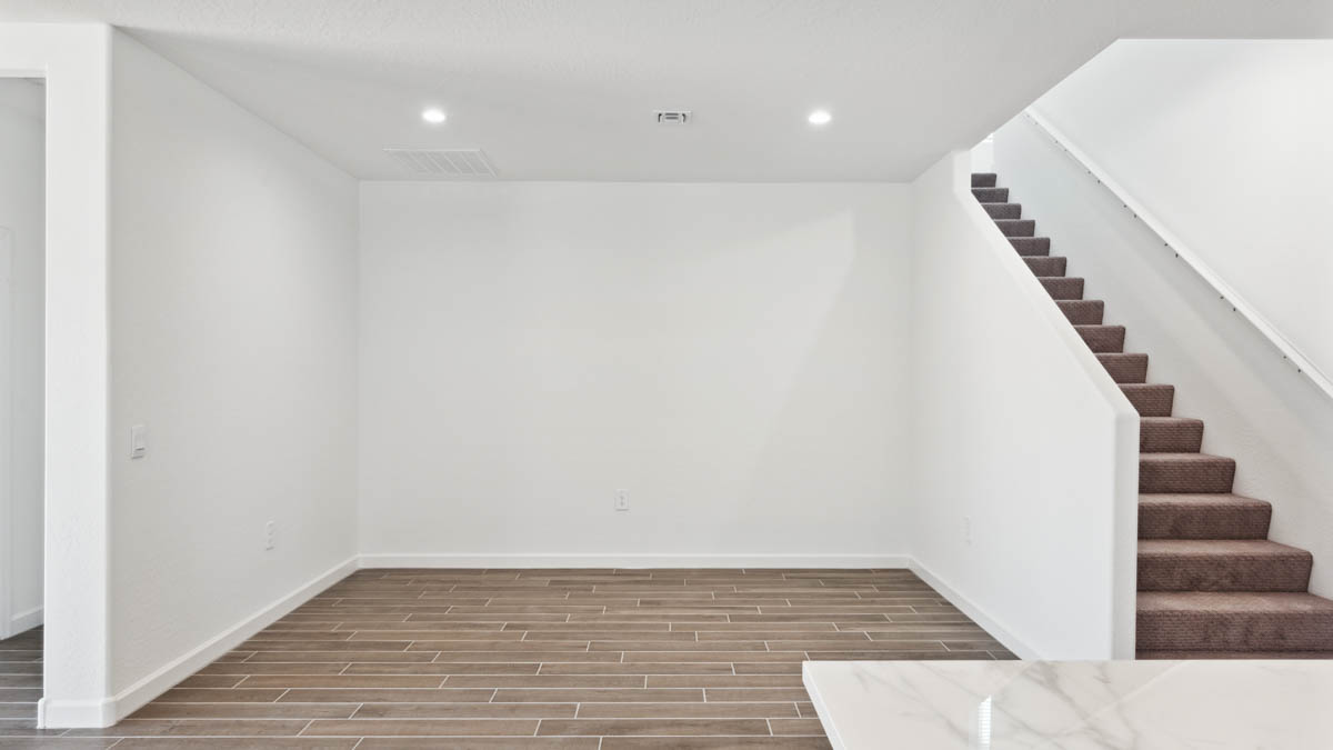 A well-organized living room that includes a kitchen and dining area, creating a warm and welcoming environment for gatherings.