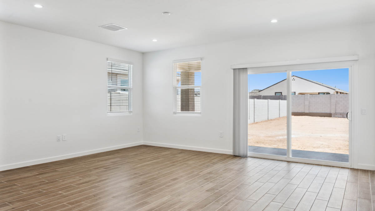 A well-organized living room that includes a kitchen and dining area, creating a warm and welcoming environment for gatherings.