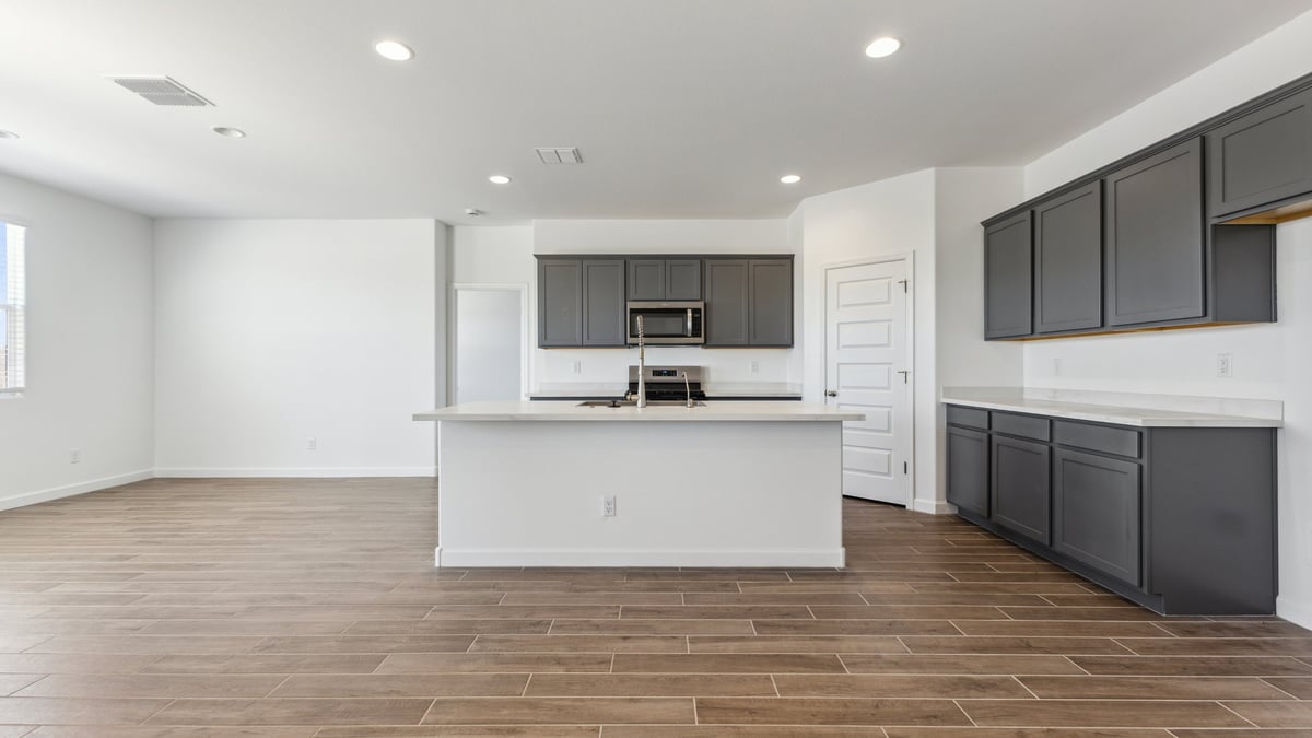 Kitchen and dining nook with entry to primary bedroom