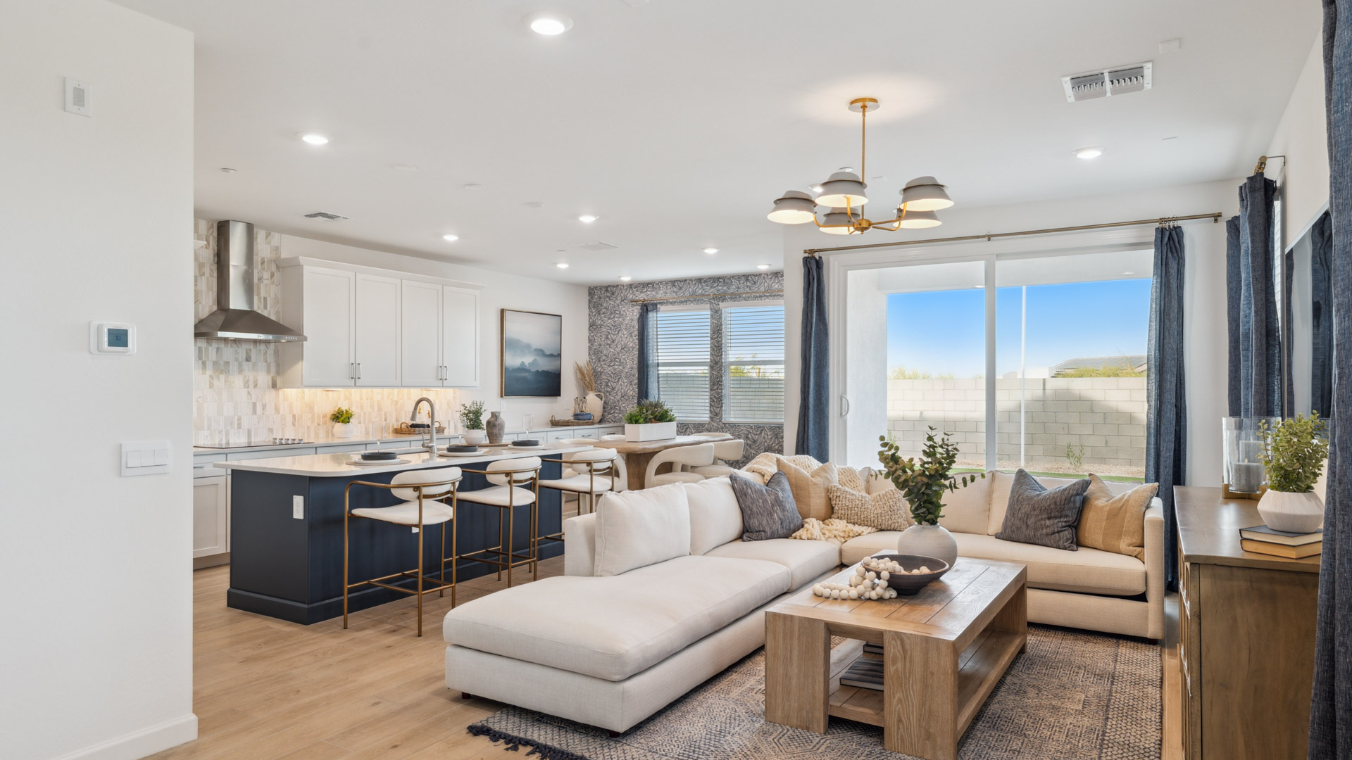 A well-organized living room that includes a kitchen and dining area, creating a warm and welcoming environment for gatherings.