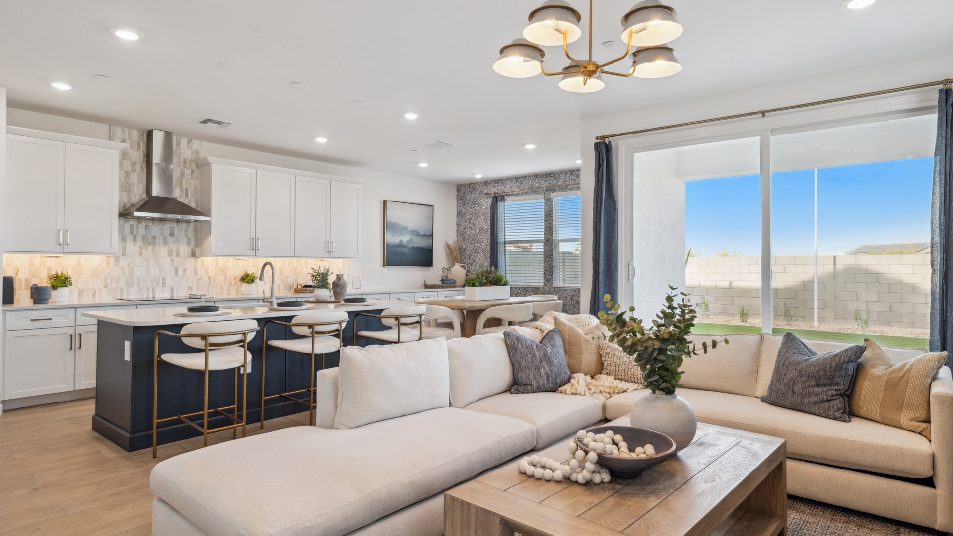 A well-organized living room that includes a kitchen and dining area, creating a warm and welcoming environment for gatherings.
