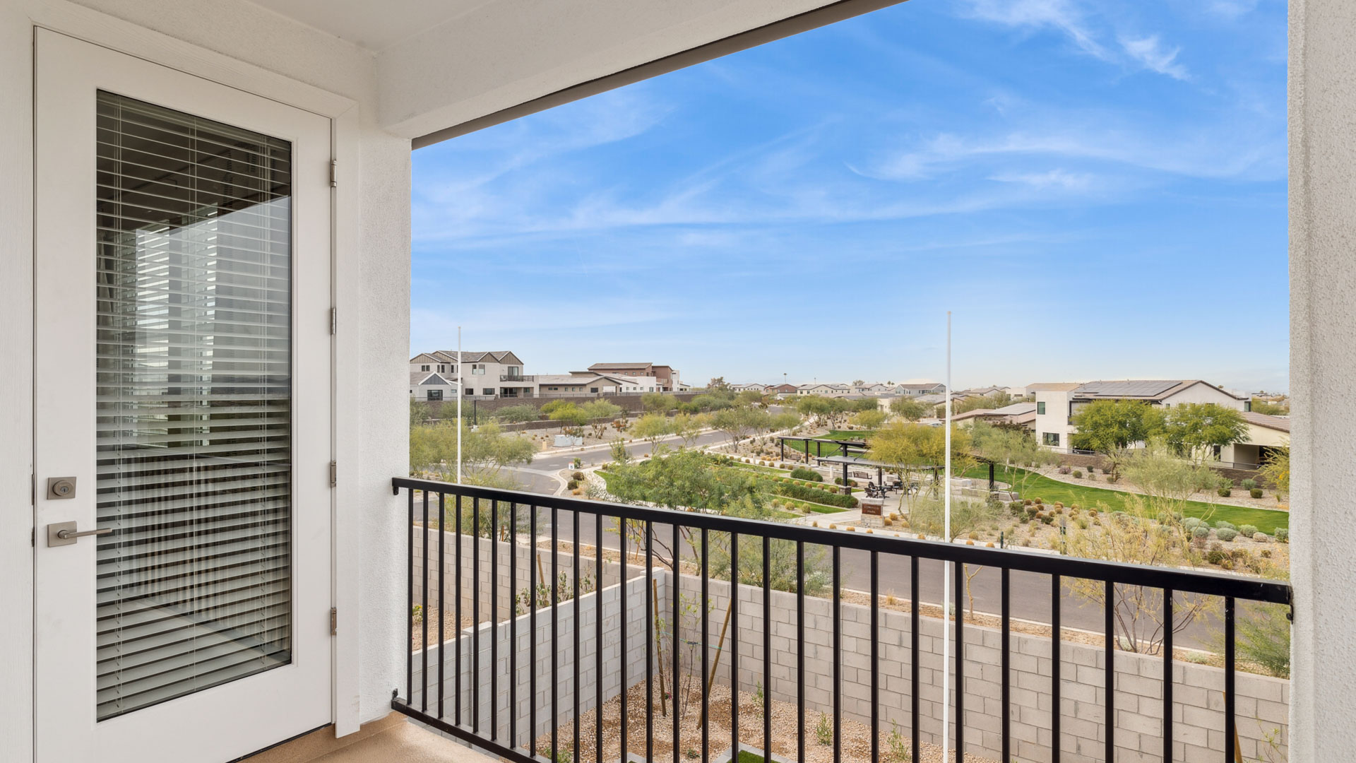 A spacious primary bedroom emphasizing open space and natural lighting and a balcony.