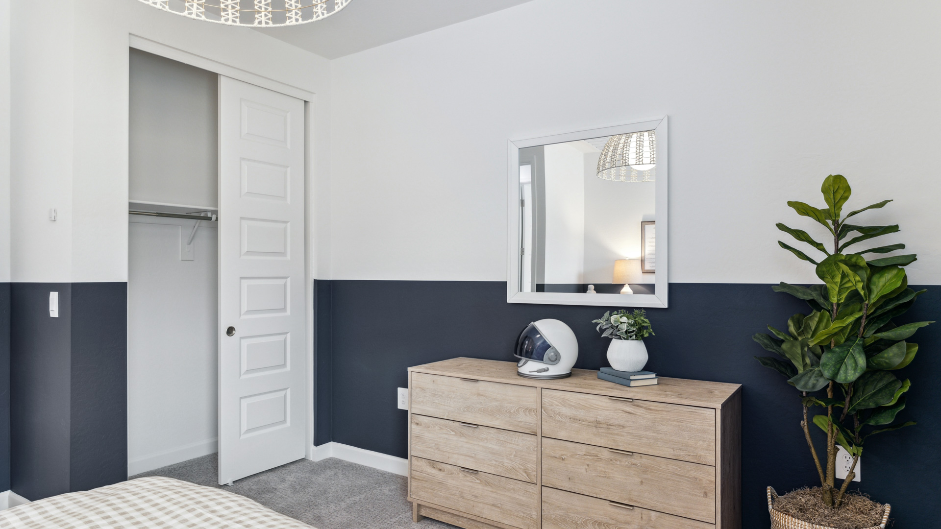 Comfortable guest bedroom featuring neutral-toned walls and a large closet.