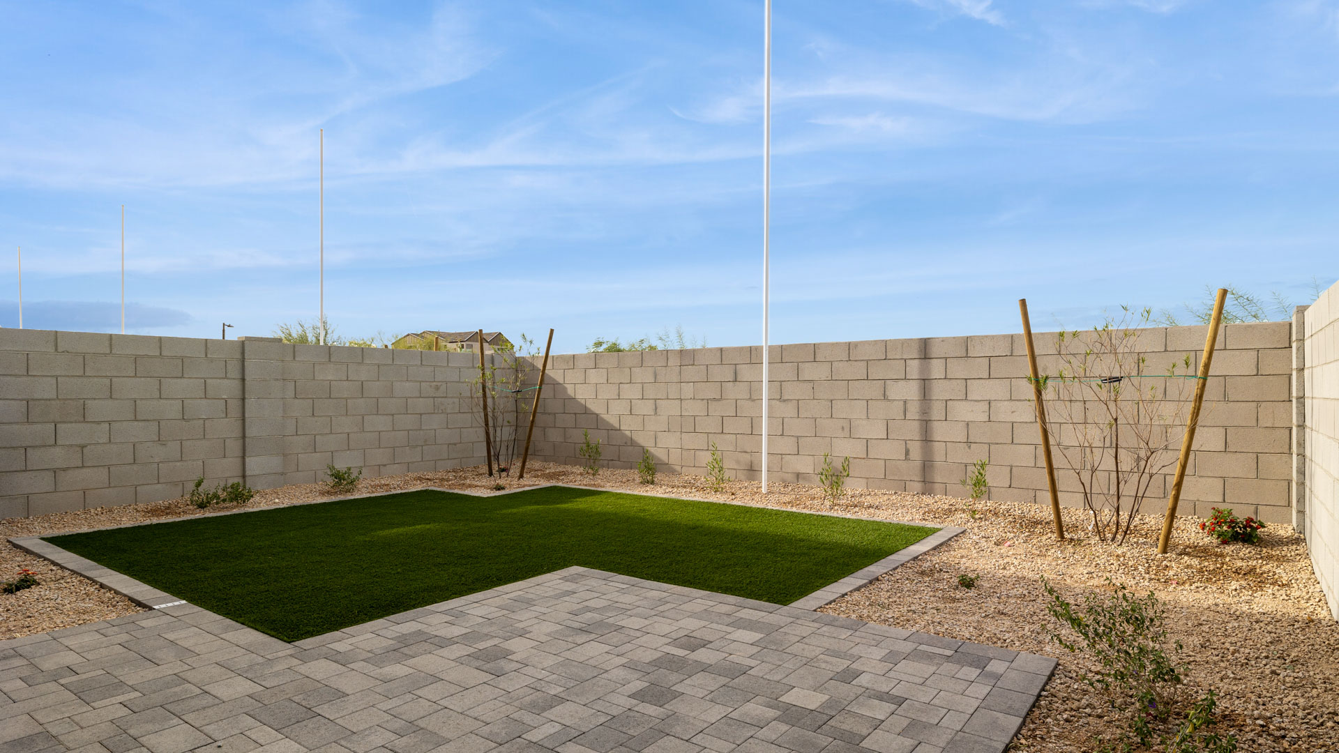 Large fenced-in backyard with a covered patio, perfect for outdoor entertaining.