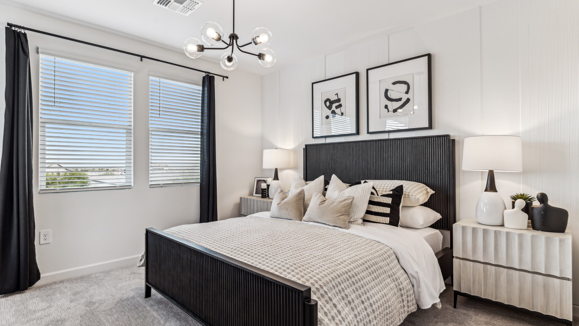 Primary bedroom features ample space, double windows, soft carpet, a stylish walk-in closet, and a private ensuite bath