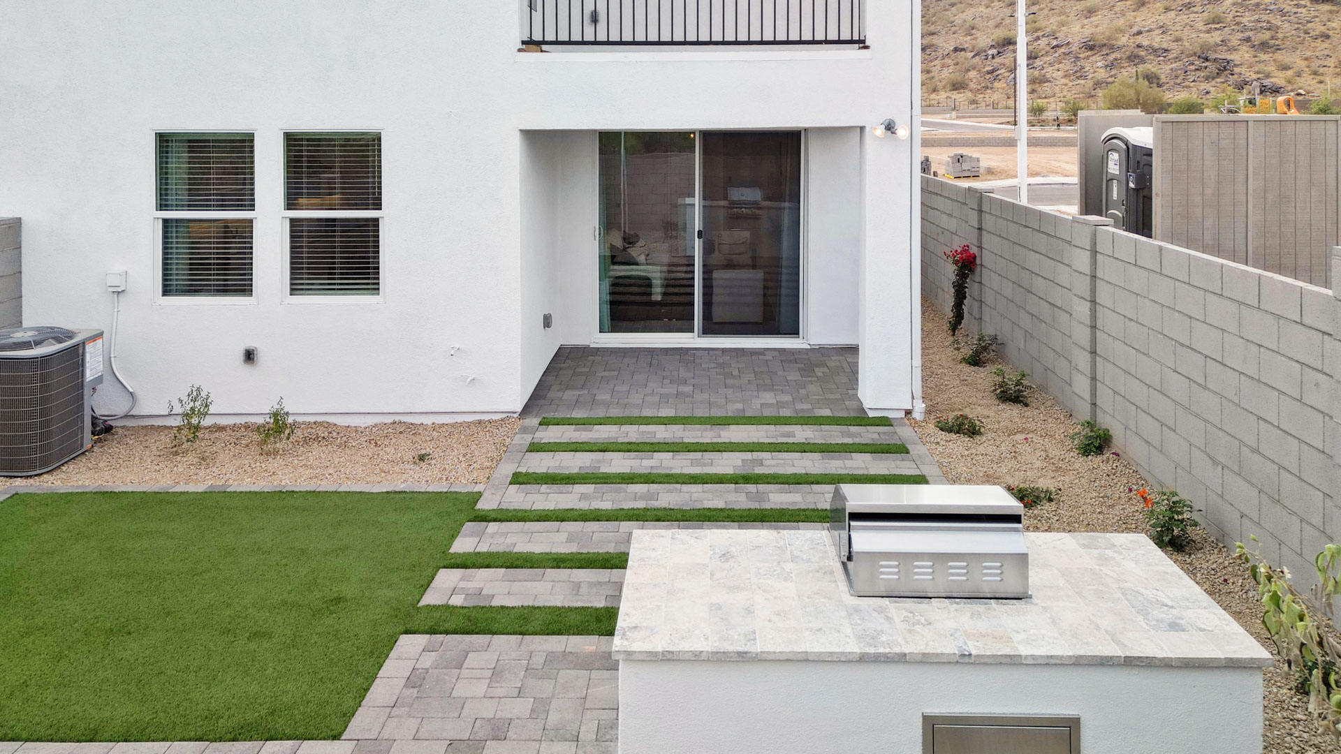 Avance private backyard featuring covered concrete patios with space for seating and grill setup