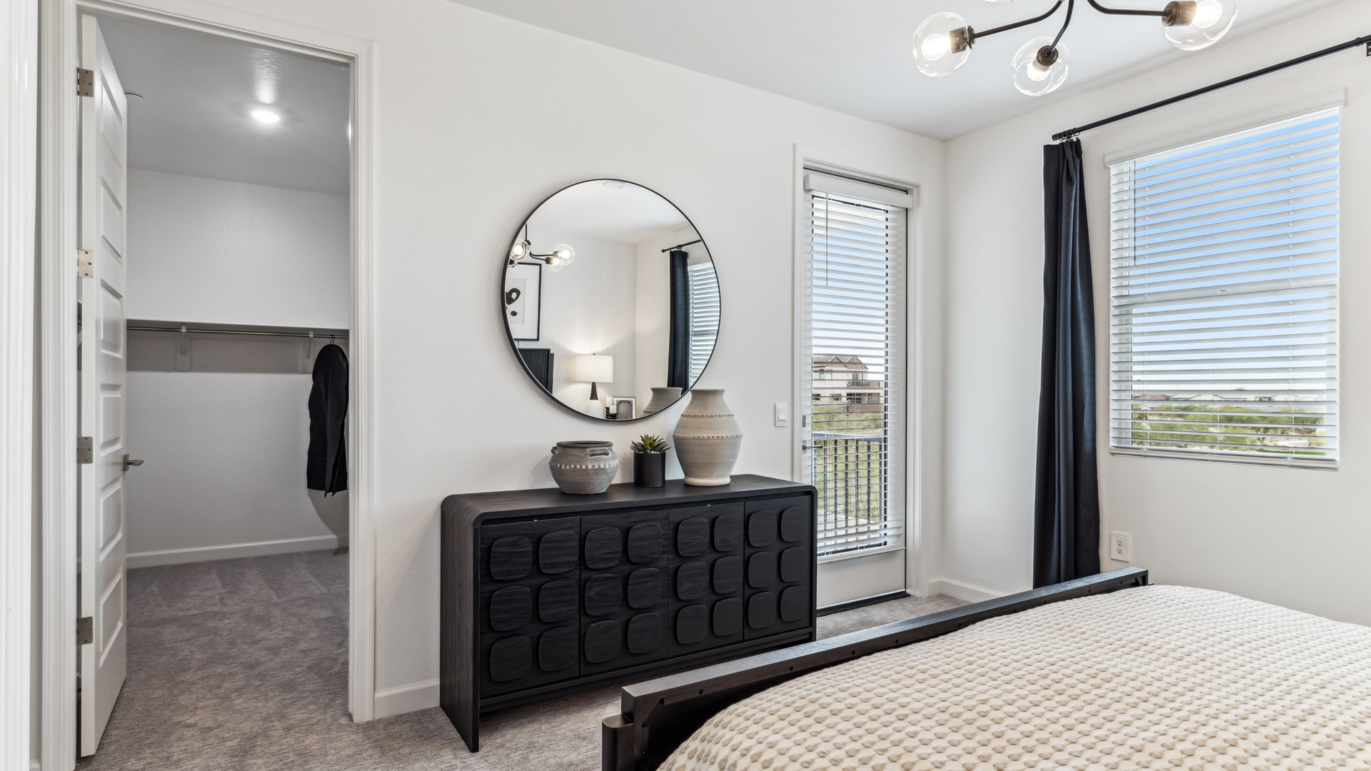primary suite with balcony and walk in closet