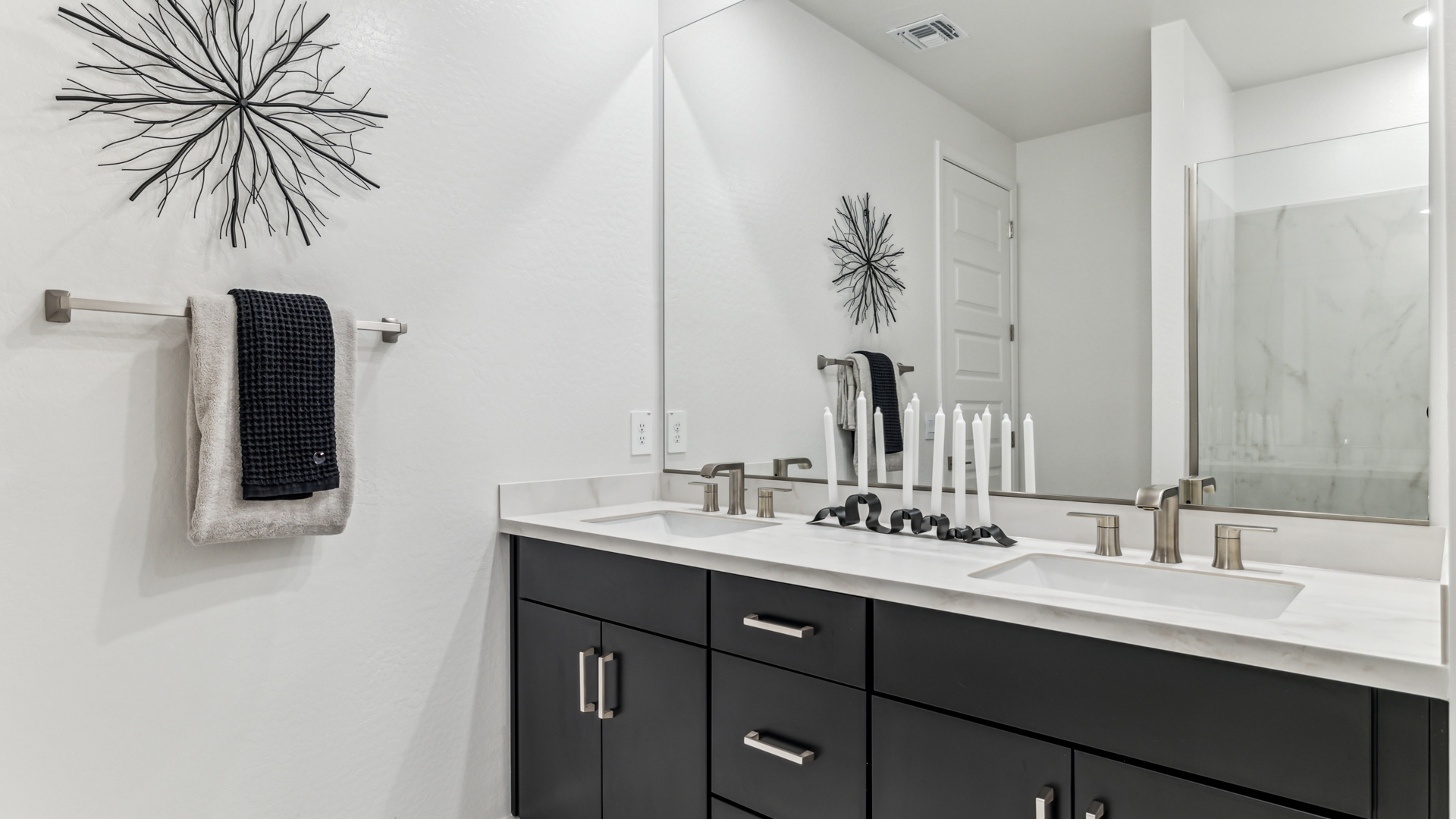primary bathroom with dual vanities
