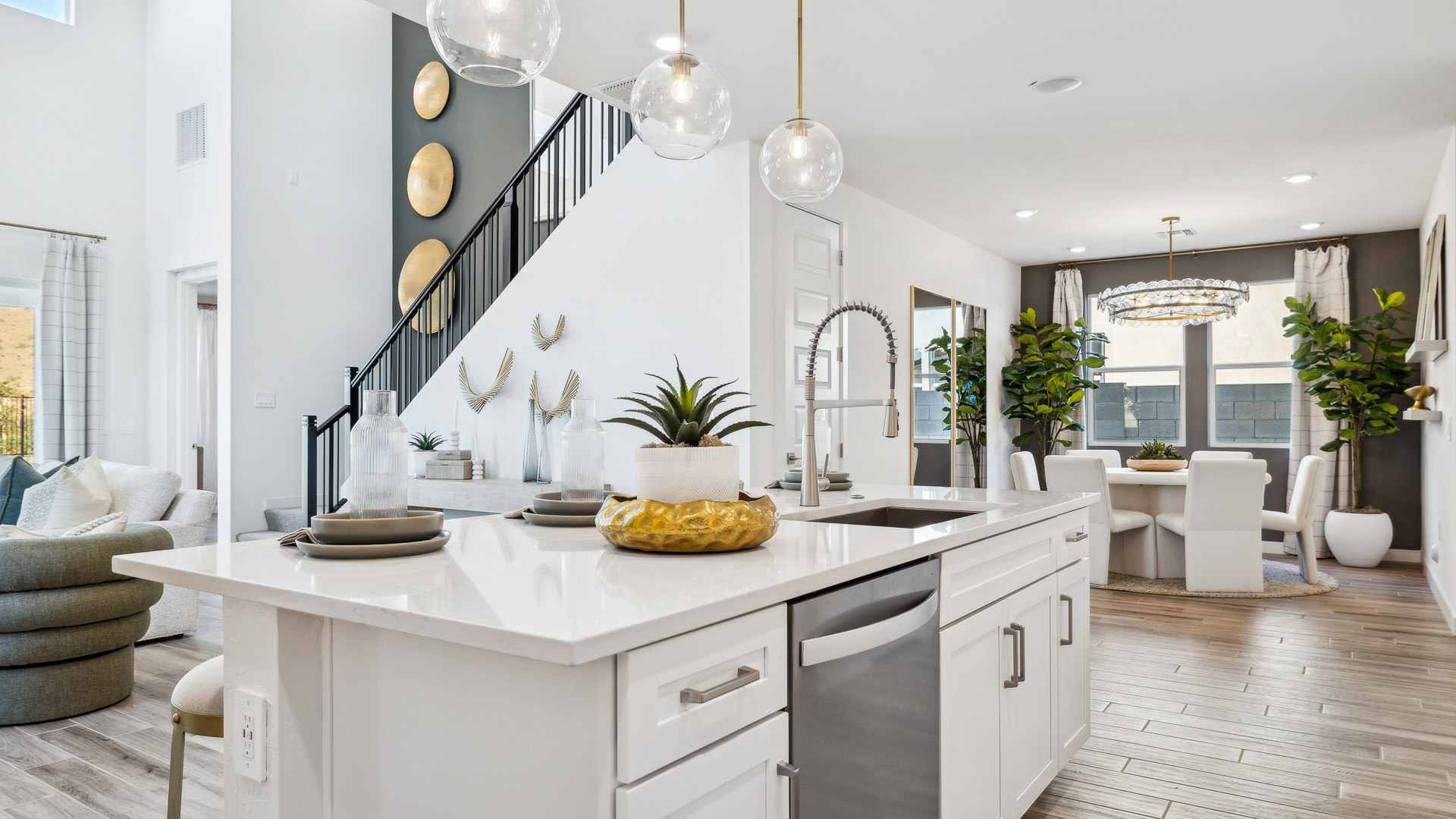 Bright and spacious kitchen with quartz countertops, stainless steel appliances, and an island with bar seating.