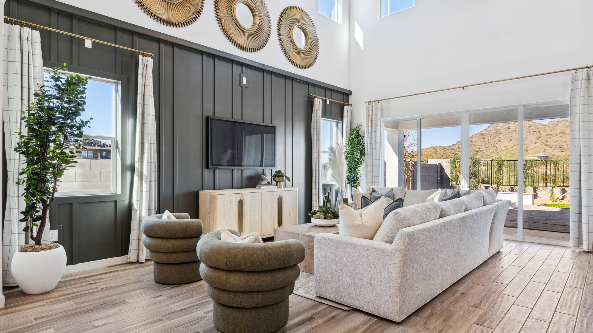 A well-organized living room that includes a kitchen and dining area, creating a warm and welcoming environment for gatherings.