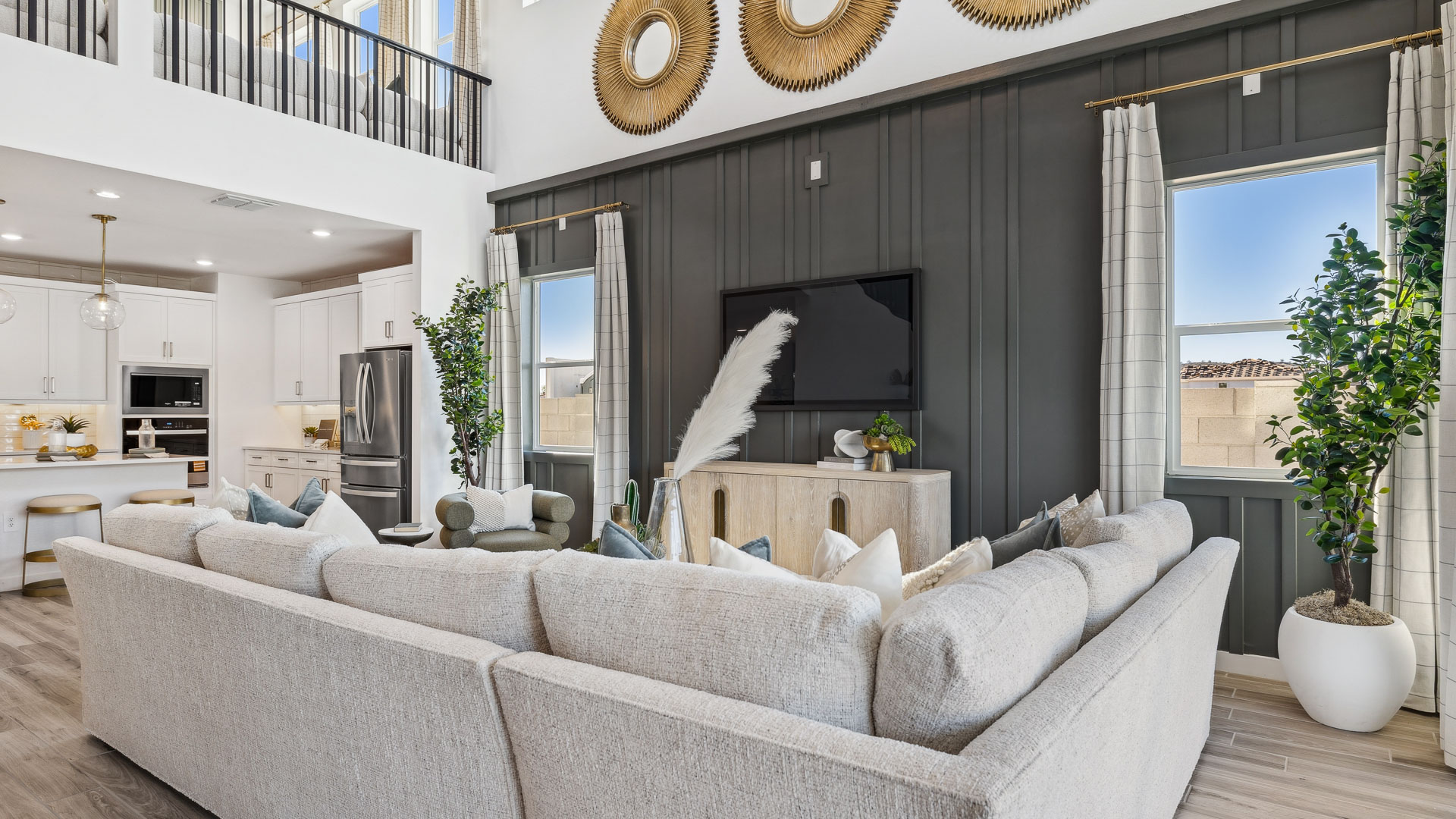 A well-organized living room that includes a kitchen and dining area, creating a warm and welcoming environment for gatherings.