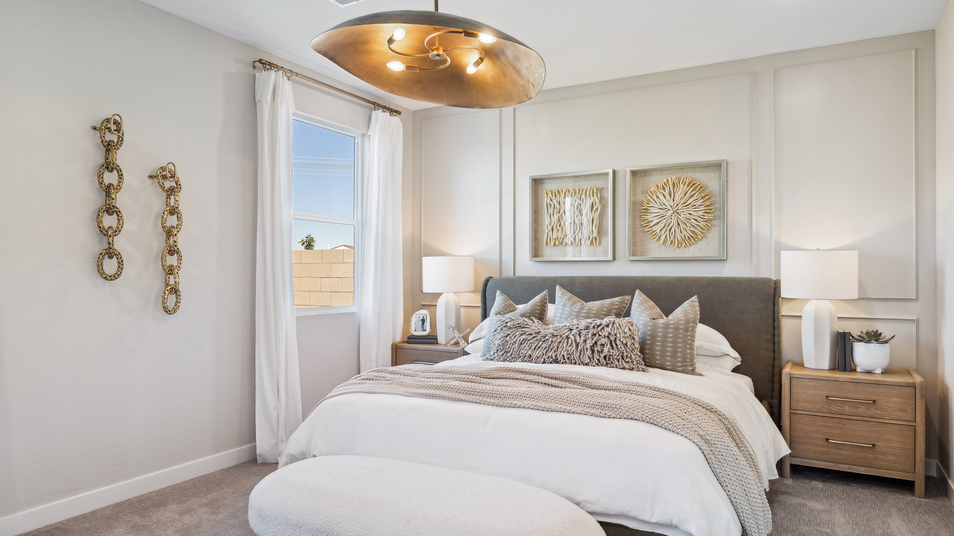 A spacious primary bedroom emphasizing open space and natural lighting.