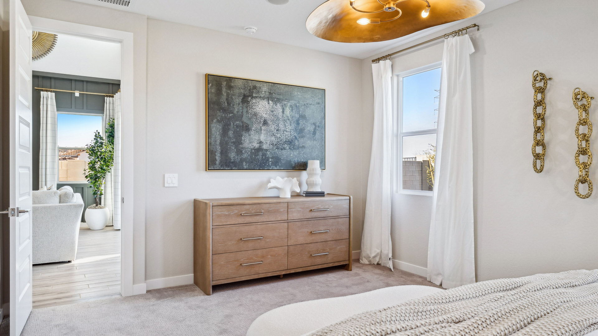 A spacious primary bedroom emphasizing open space and natural lighting.