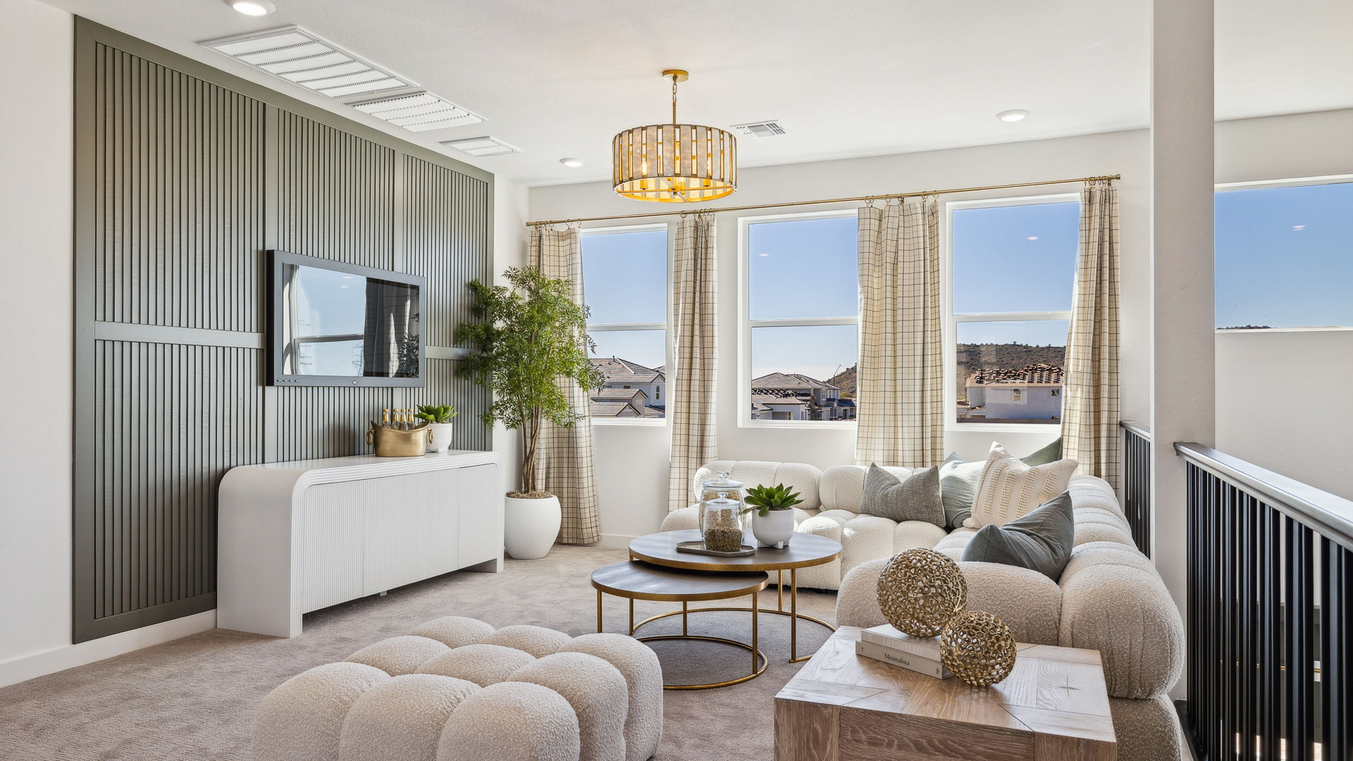 A cozy living room upstairs featuring a comfortable couch, a stylish coffee table, and an elegant painting on the wall.