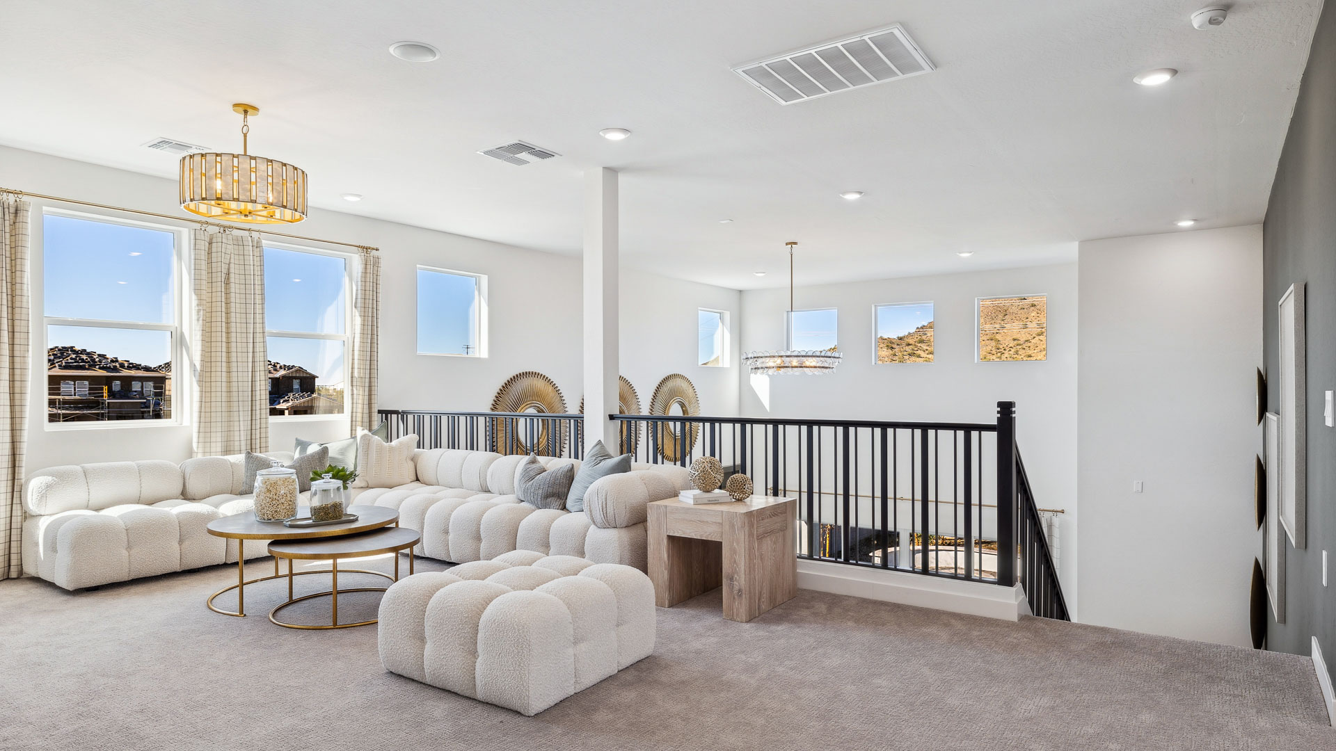 A cozy living room upstairs featuring a comfortable couch, a stylish coffee table, and an elegant painting on the wall.