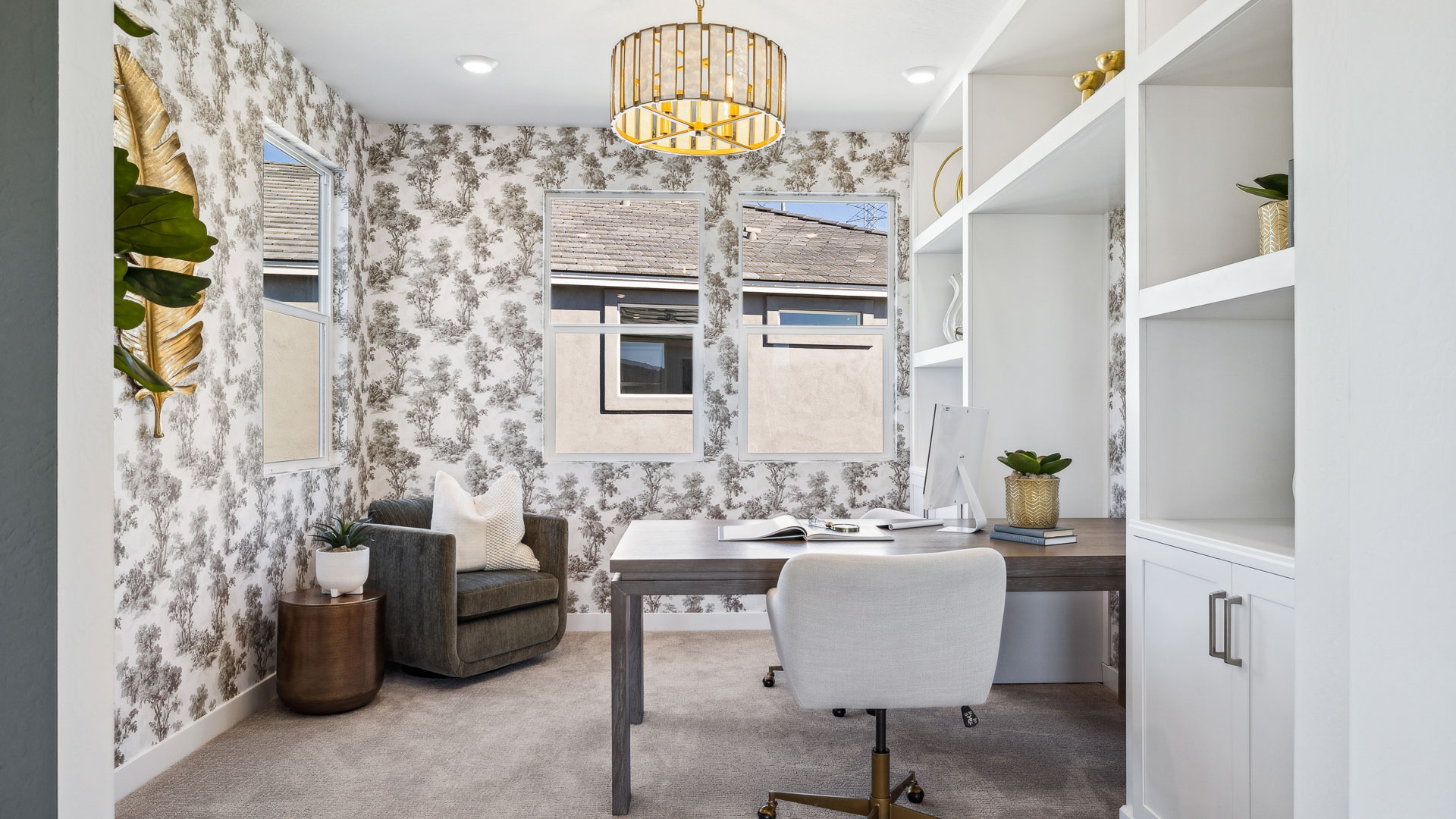 A tidy office featuring a desk, chair, and a window, creating a bright and organized workspace.