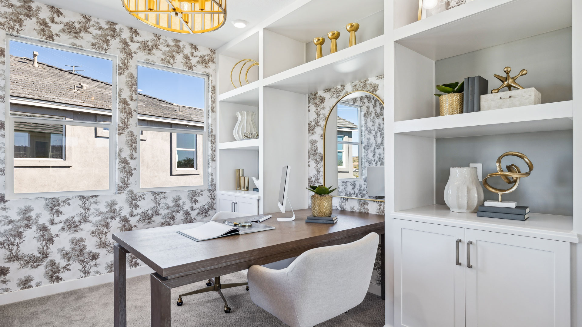 A tidy office featuring a desk, chair, and a window, creating a bright and organized workspace.