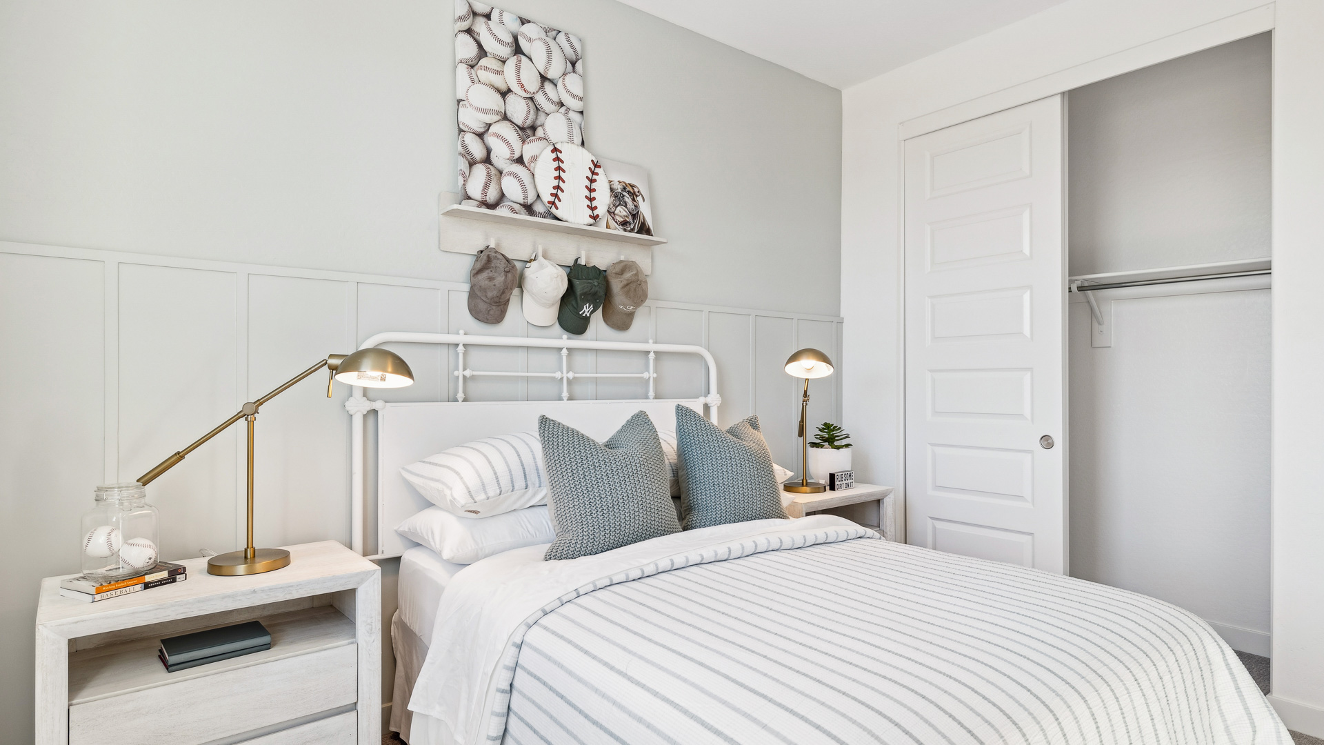 A vibrant kids' bedroom showcasing a neatly made bed, a stylish dresser, and a playful painting that adds charm.