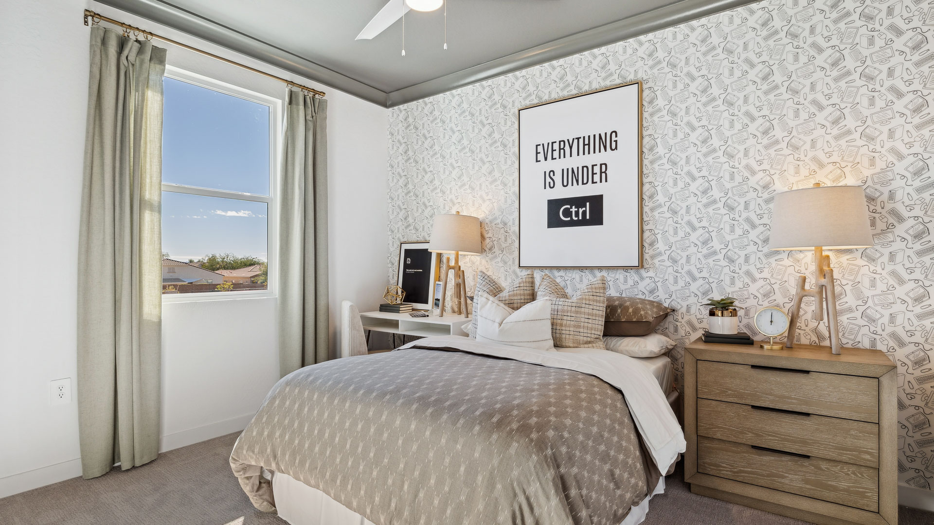 A vibrant kids' bedroom showcasing a neatly made bed, a stylish dresser, and a playful painting that adds charm.
