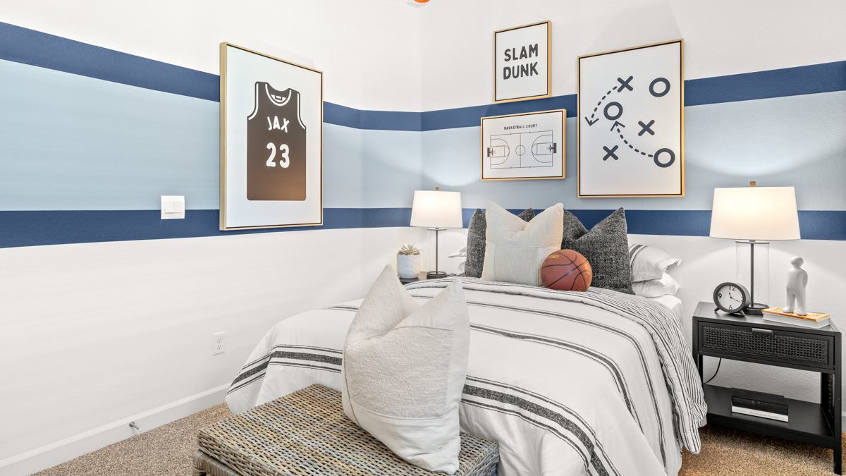 A vibrant kids' bedroom showcasing a neatly made bed, a stylish dresser, and a playful painting that adds charm.