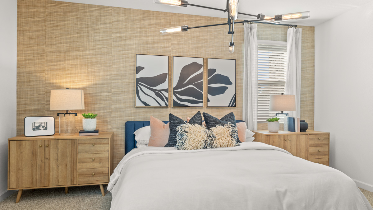 A spacious primary bedroom emphasizing open space and natural lighting.