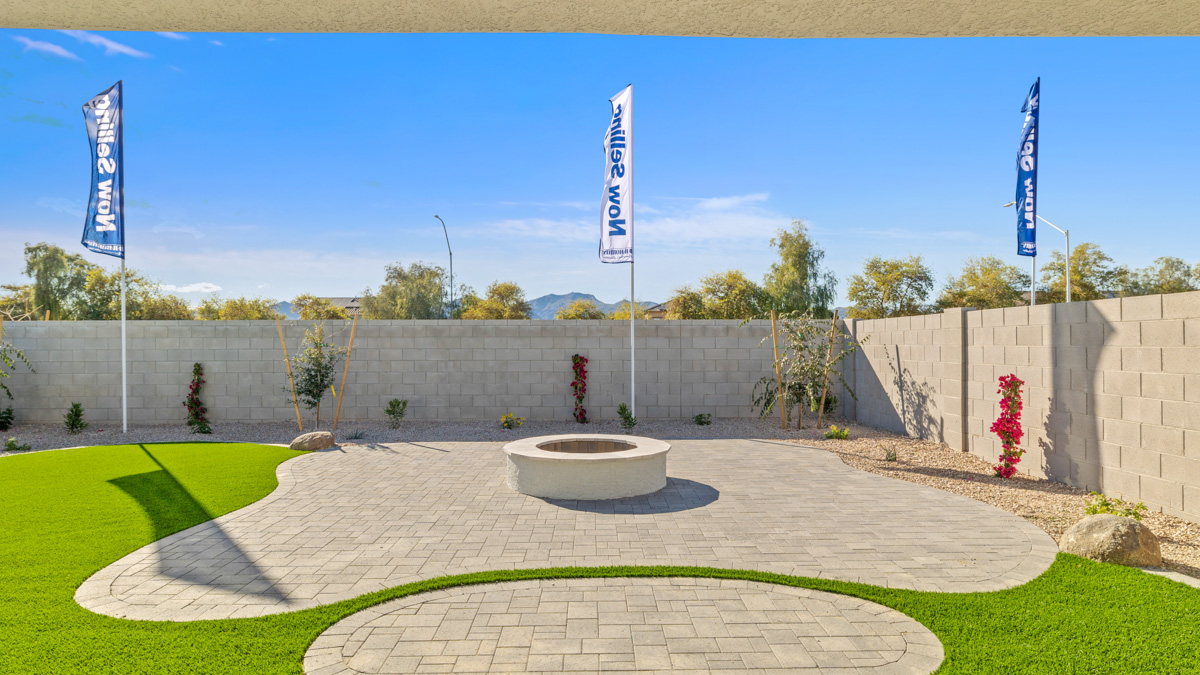 Large fenced-in backyard with a covered patio, perfect for outdoor entertainment.