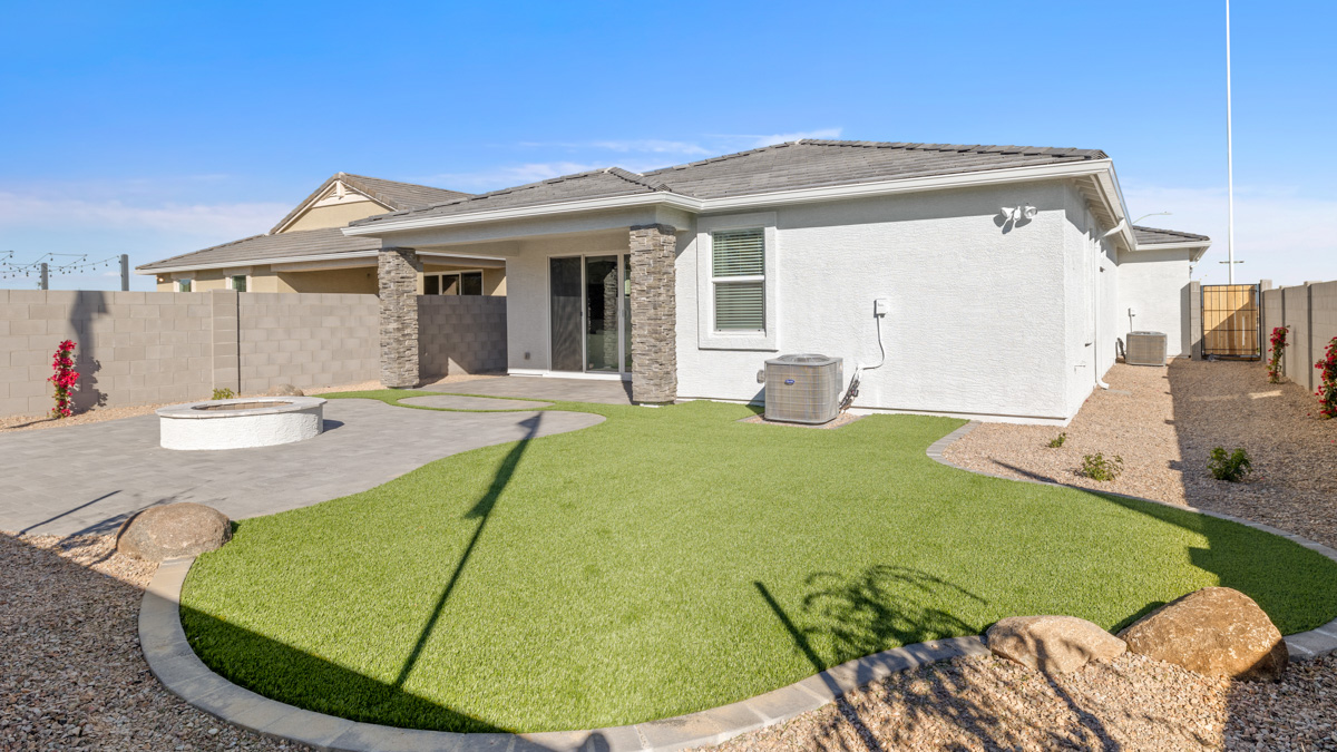 Large fenced-in backyard with a covered patio, perfect for outdoor entertainment.