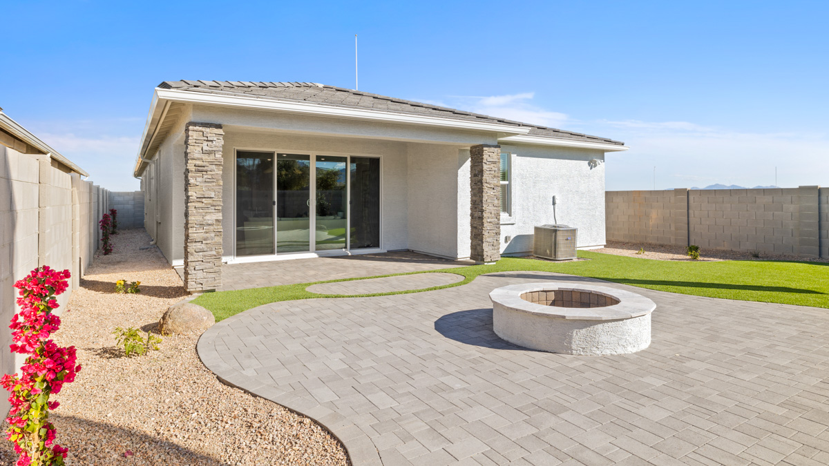 Large fenced-in backyard with a covered patio, perfect for outdoor entertainment.