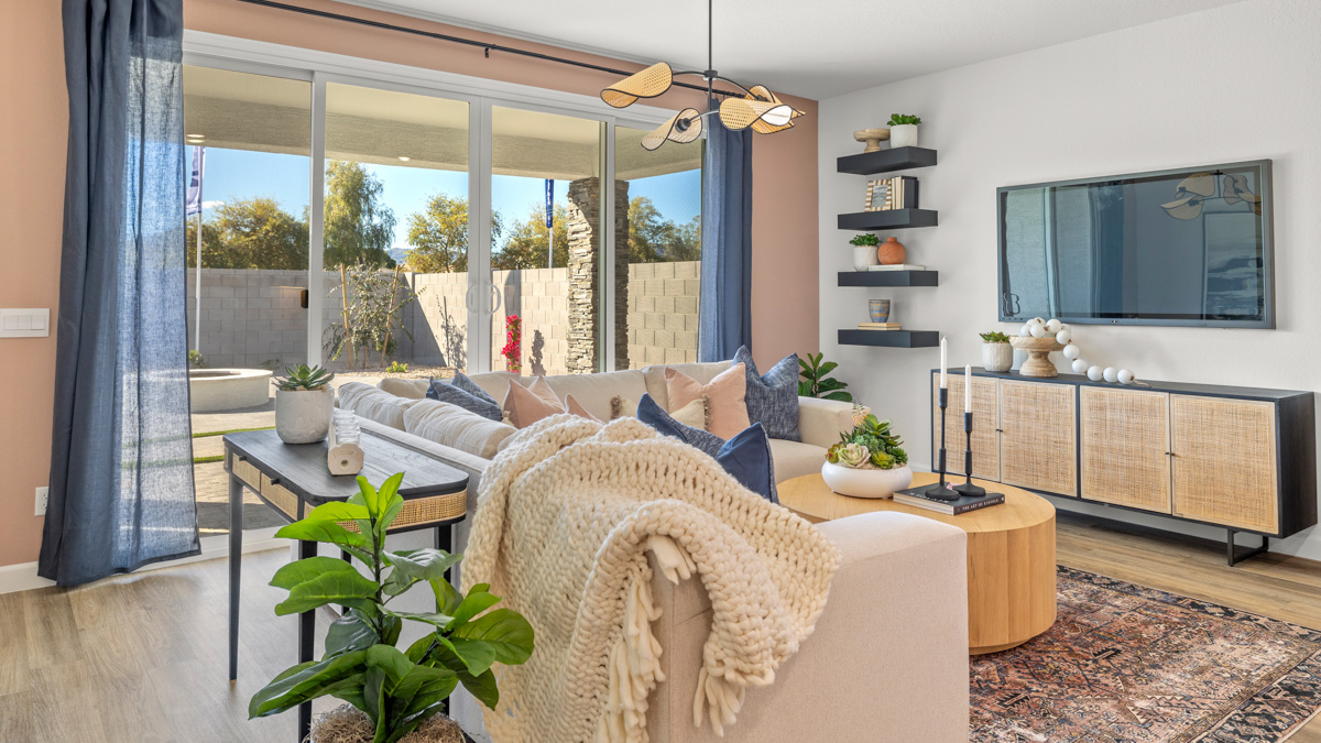 A well-organized living room that includes a kitchen and dining area, creating a warm and welcoming environment for gatherings.