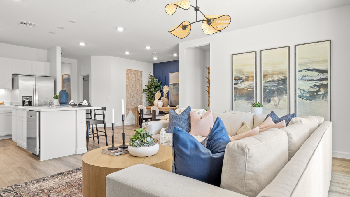A well-organized living room that includes a kitchen and dining area, creating a warm and welcoming environment for gatherings.