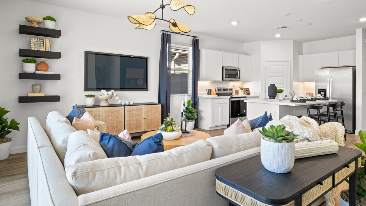 A well-organized living room that includes a kitchen and dining area, creating a warm and welcoming environment for gatherings.