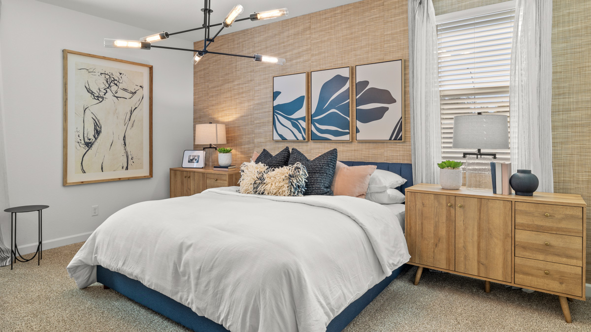 A spacious primary bedroom emphasizing open space and natural lighting.