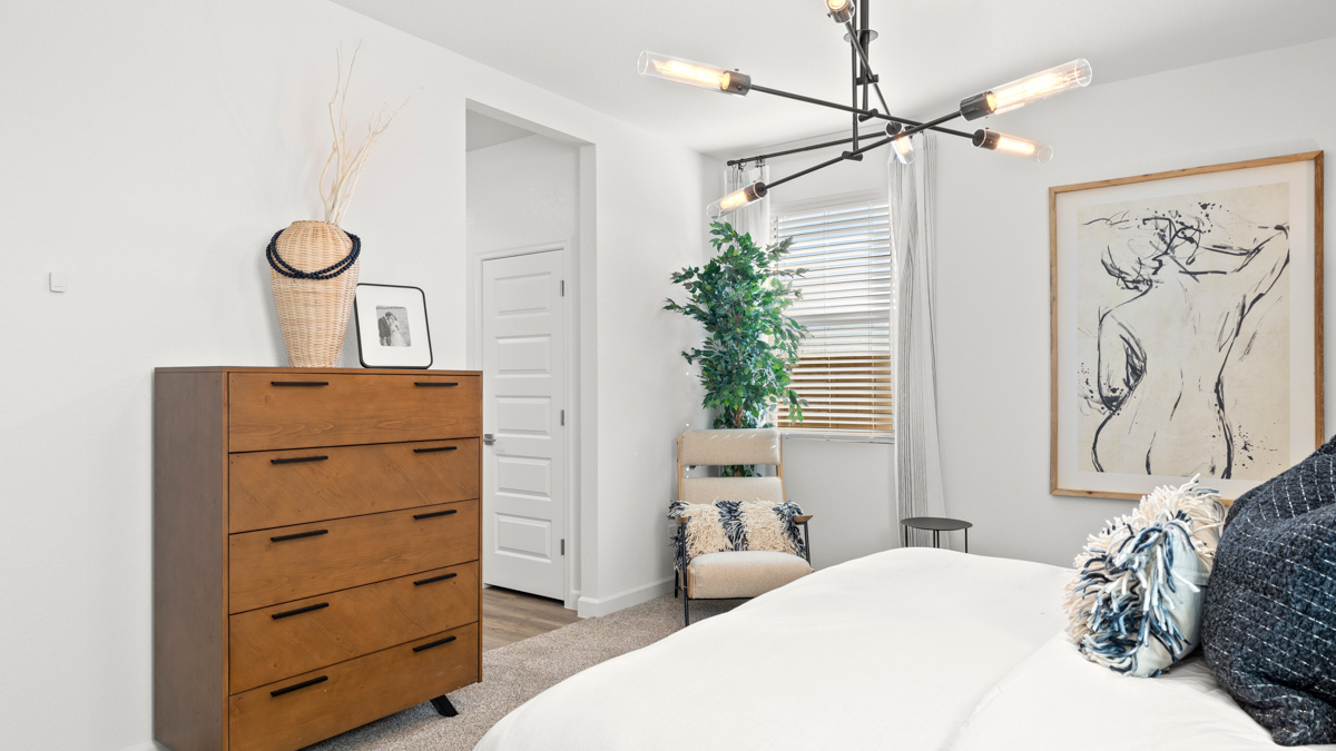 A spacious primary bedroom emphasizing open space and natural lighting.