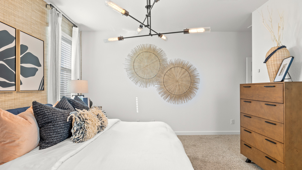 A spacious primary bedroom emphasizing open space and natural lighting.