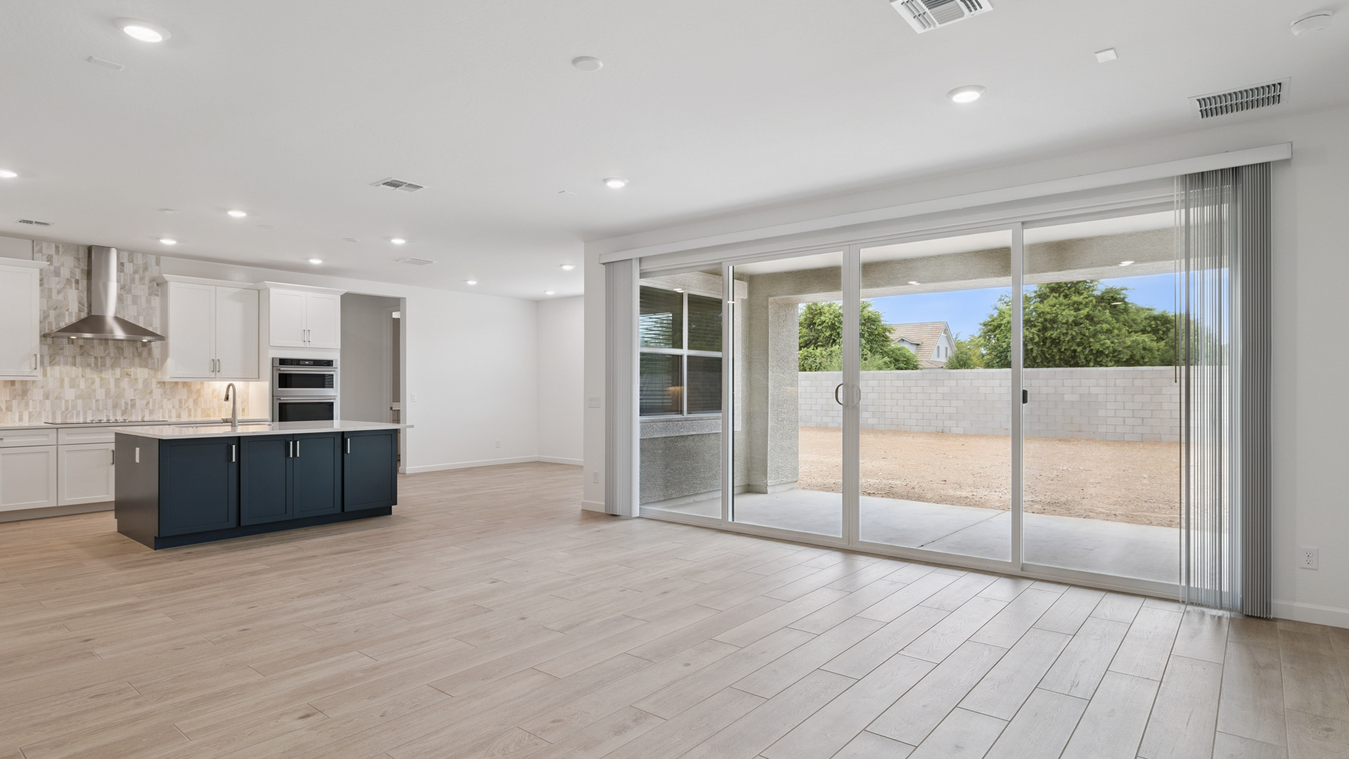 A well-organized living room that includes a kitchen and dining area, creating a warm and welcoming environment for gatherings.