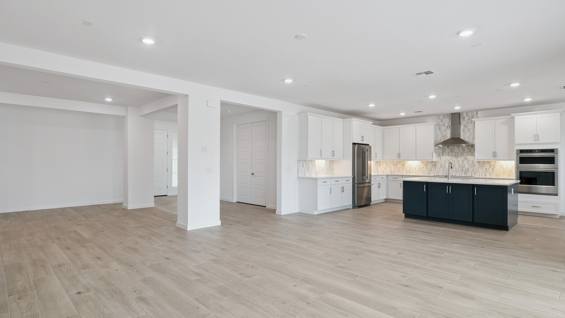 A well-organized living room that includes a kitchen and dining area, creating a warm and welcoming environment for gatherings.